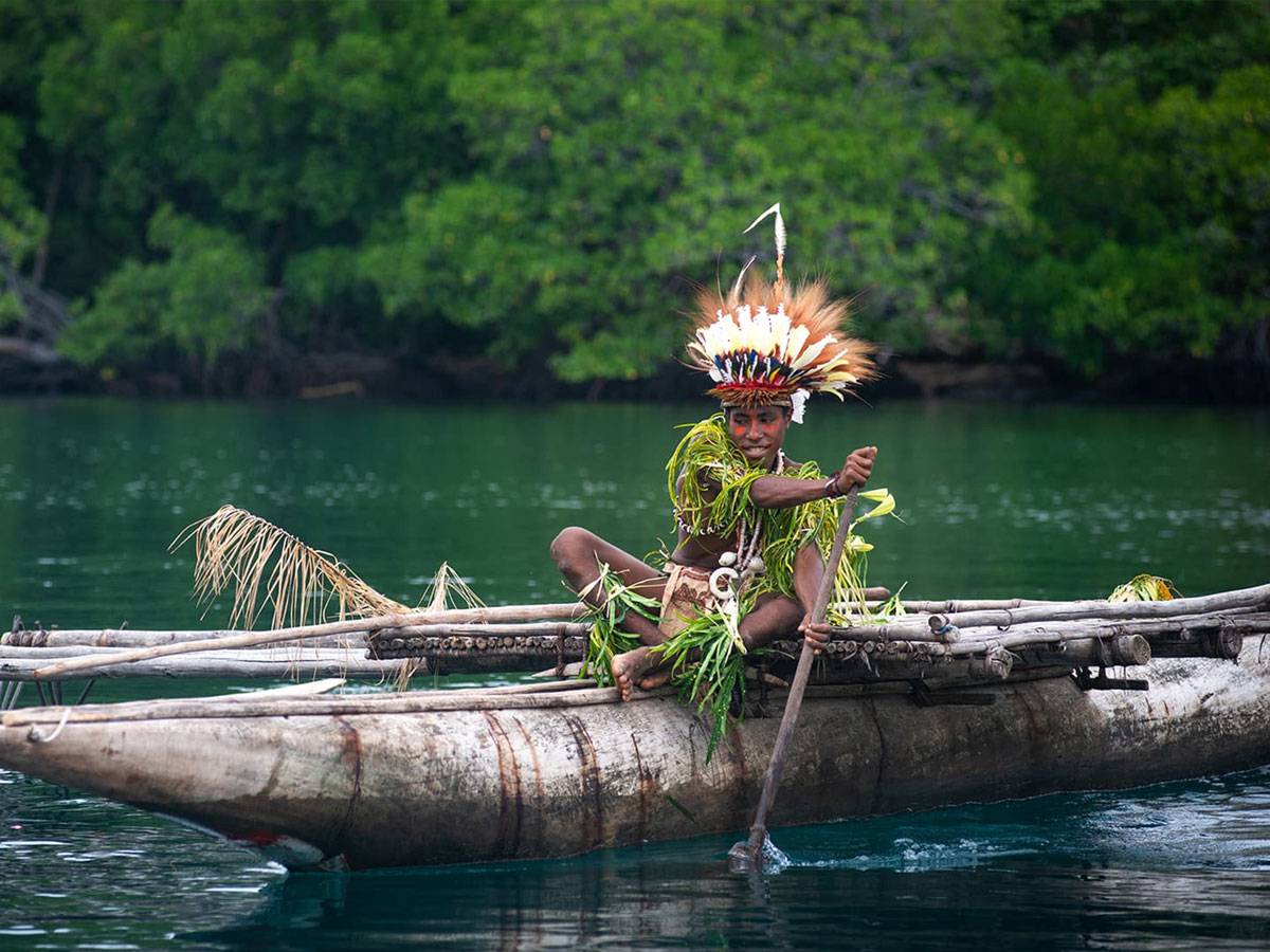 Traditional Papua man on canoe